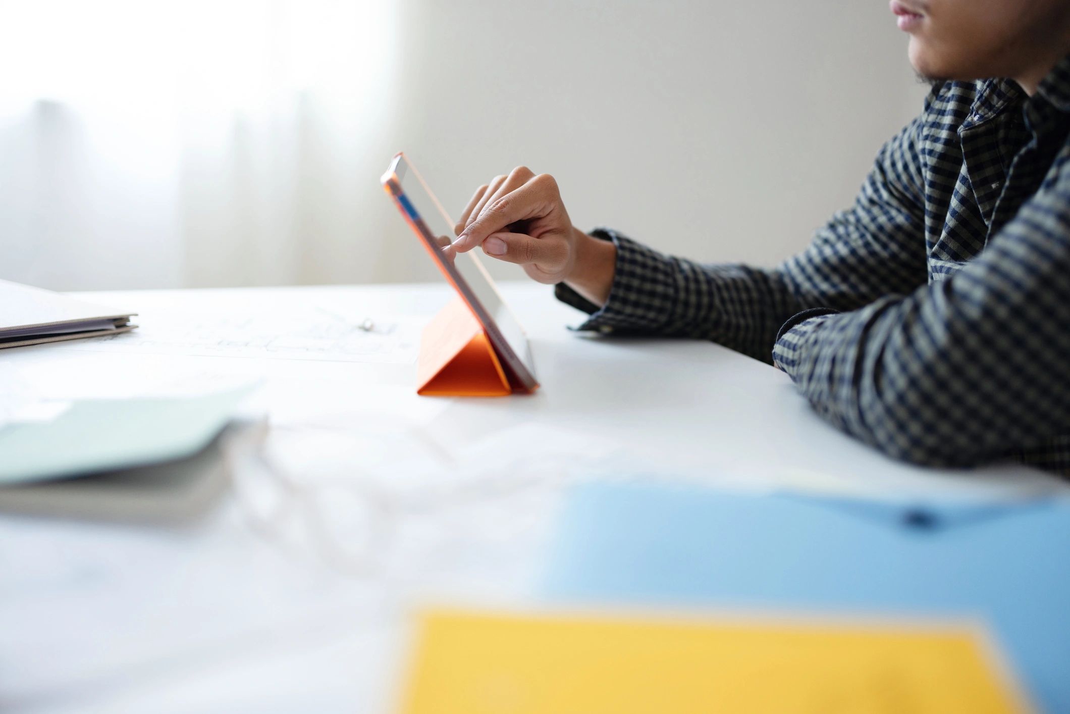Researcher reviewing thesis documents at a desk